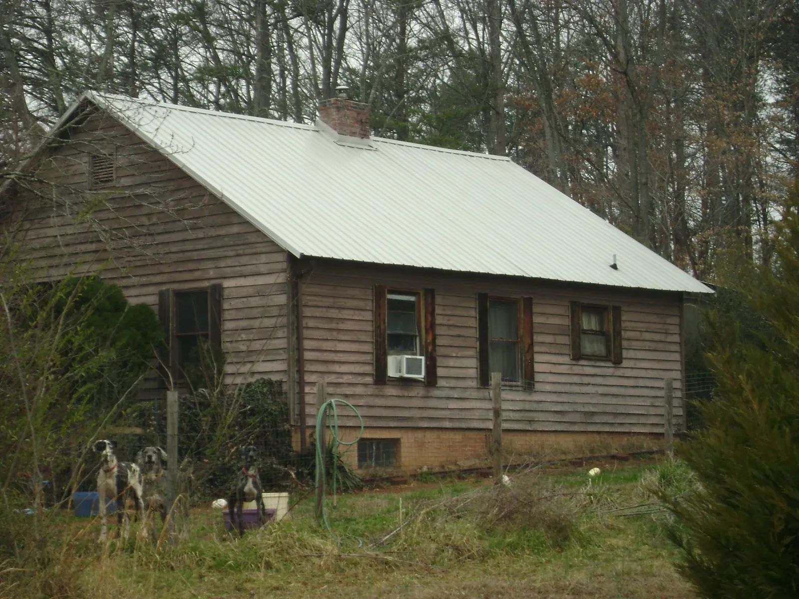 White metal roof on an old wood sided farmhouse, from a Metal Roof Installation job in Elk River